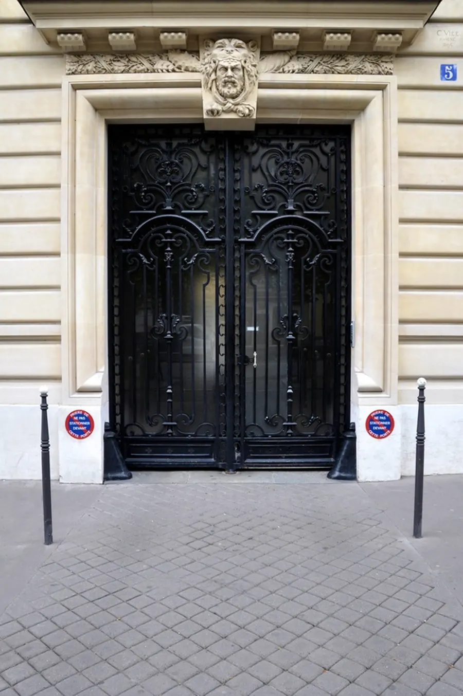 A Paris apartment door with its number, in soft daylight.